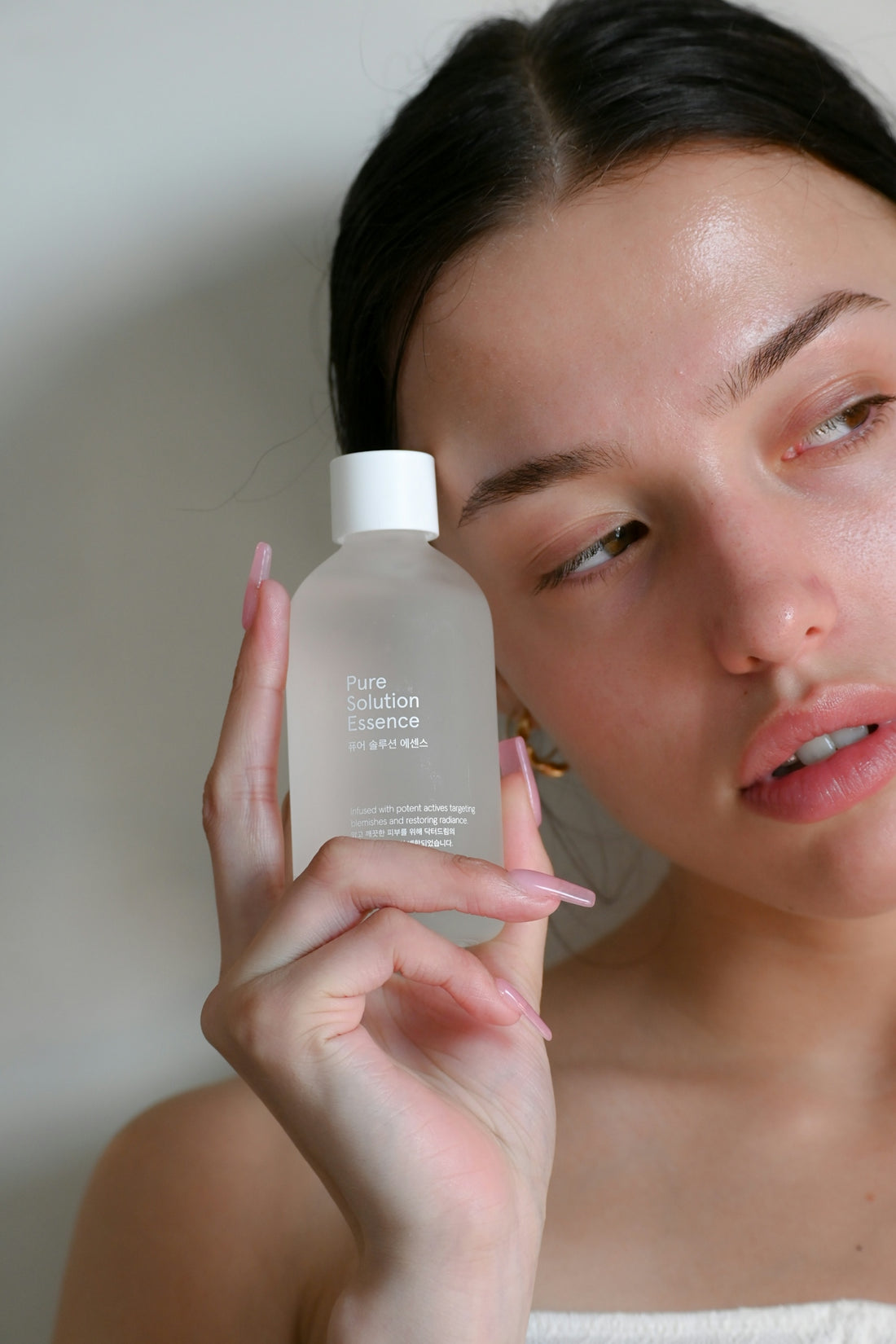 a woman holding a bottle