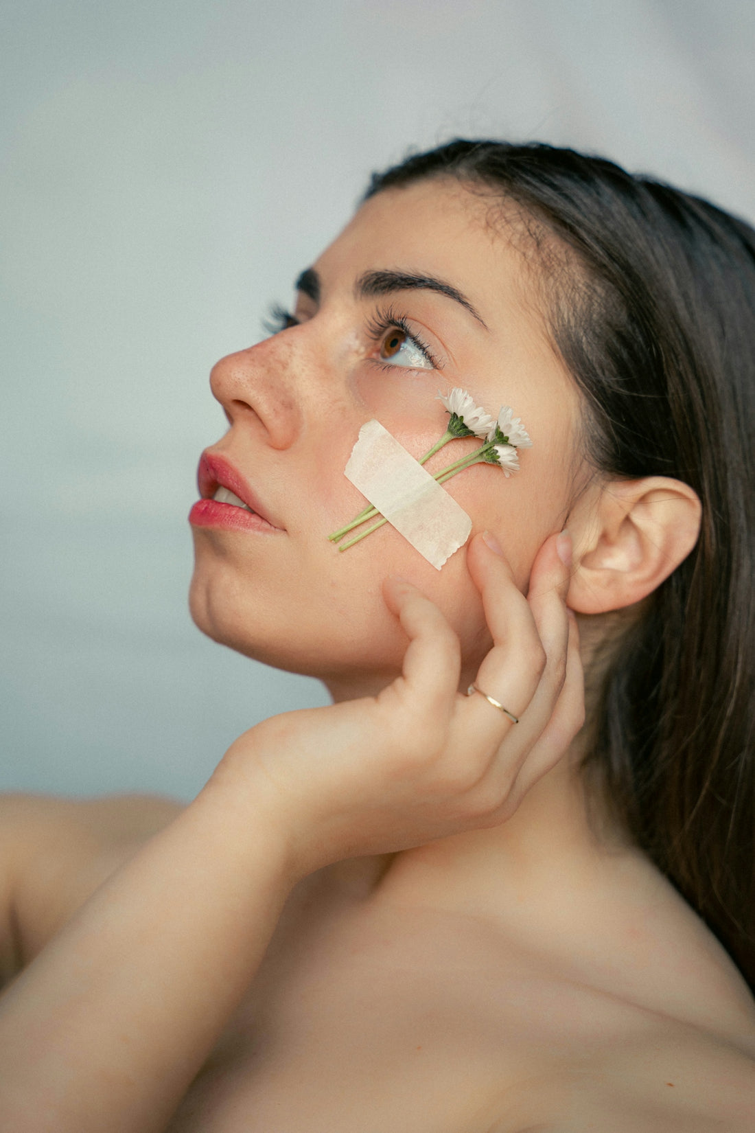 a woman with a piece of paper on her face