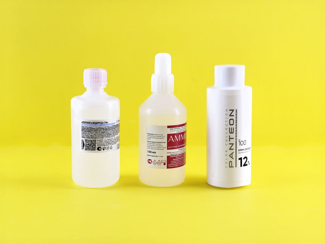 Three bottles are lined up on a yellow background.