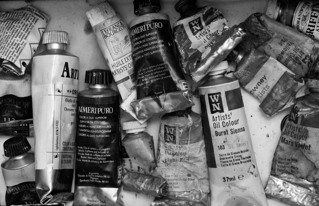 Assorted tubes of oil paint scattered together.